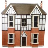 A large Tudor style painted wooden dolls house, English 20th century,