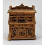 A miniature wooden desk money-box, German circa 1910,