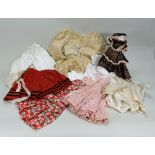 A collection of various dolls clothes,