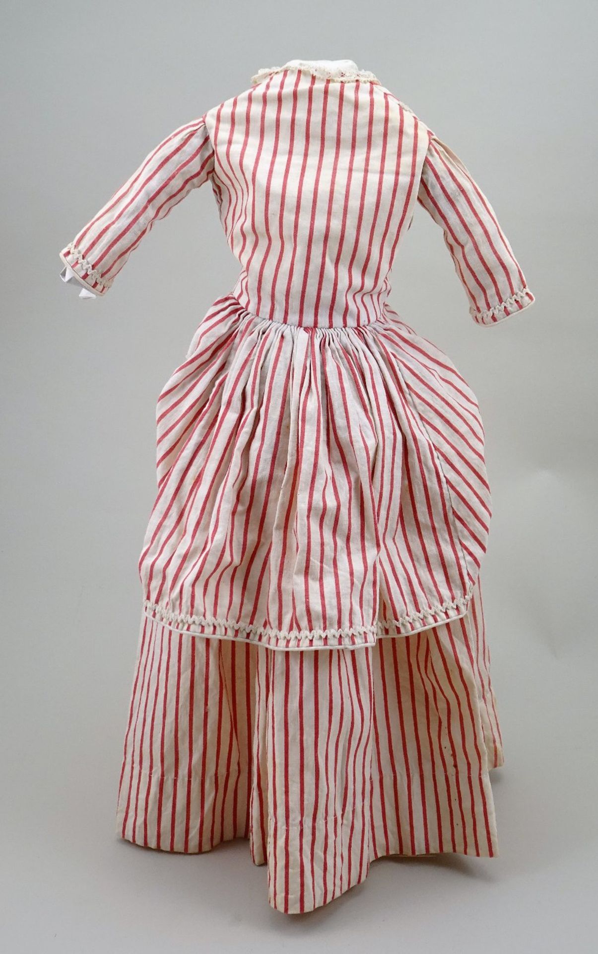 An early red and cream striped cotton dolls dress, circa 1860,