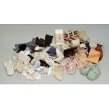 A collection of dolls socks, clothes and bonnets,