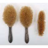 A silver dressing table brush set