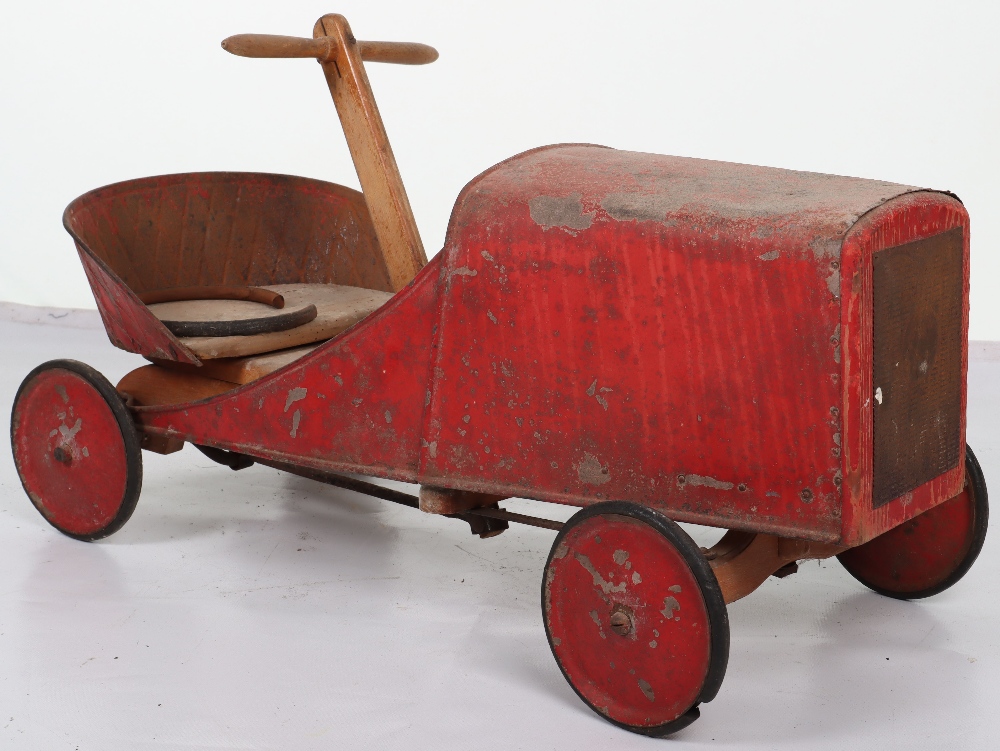 A pressed steel and wooden hand operated child’s car, French 1920s