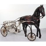 A very rare and early French pressed steel child’s pedal horse and trap, circa 1900