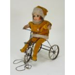 A Chad Valley Doll on Trike cloth doll, circa 1930,