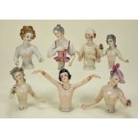 Seven 1920s glazed china half-dolls,