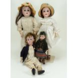 Four German bisque head dolls including a Schoenau & Hoffmeister 1909,