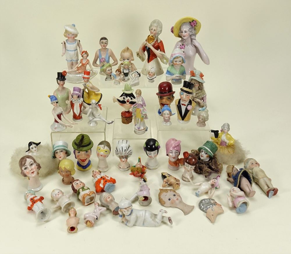 Collection of various glazed china half-dolls and pin-cushions,