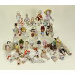 Collection of various glazed china half-dolls and pin-cushions,