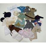A collection of dolls clothes,