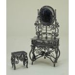 An unusual spun metal dressing table and stool,