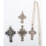 Four Russian silver and metal cross pendants