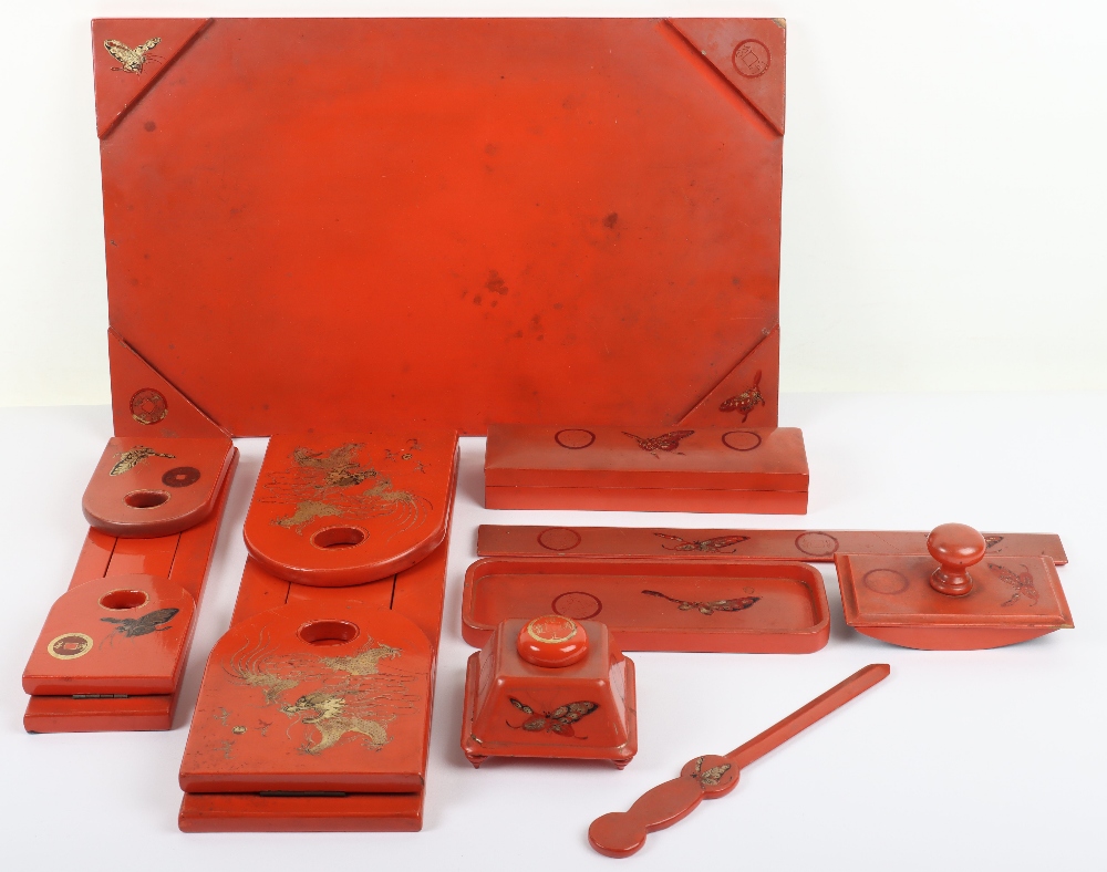 A 20th century Japanese red lacquer desk set