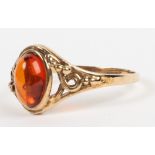 A 9ct gold and amber single stone ring