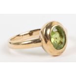 A 9ct gold and peridot single stone ring