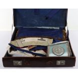 A leather suitcase of Masonic regalia, including aprons, cuffs, and decorations, (qty)