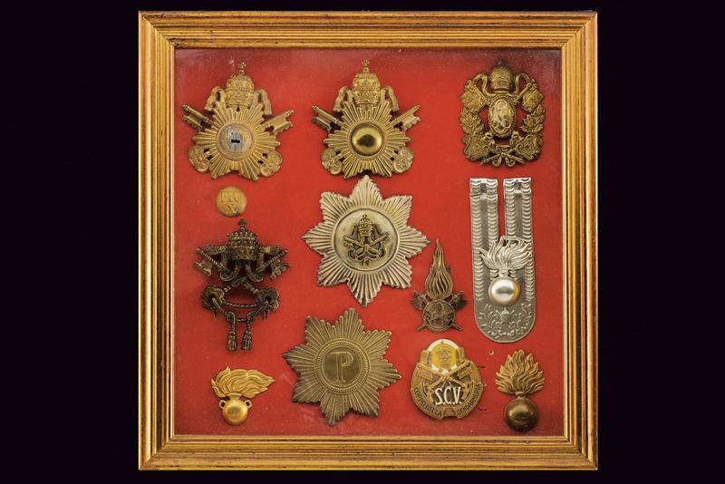 A glass case with Papal army badges