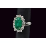 White gold oval 4.0 cts emerald ring with diamond surround