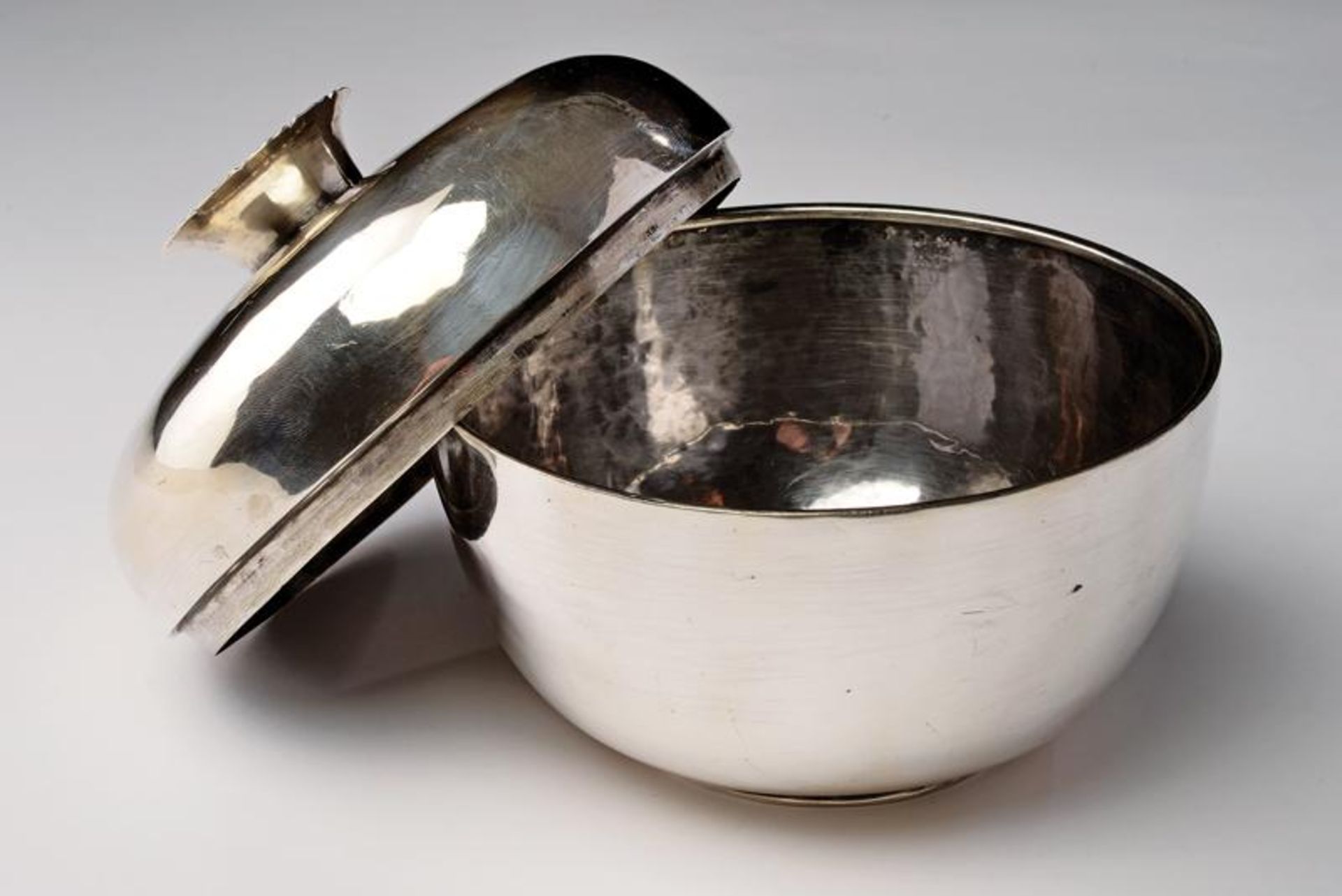 A sterling silver bowl with cover