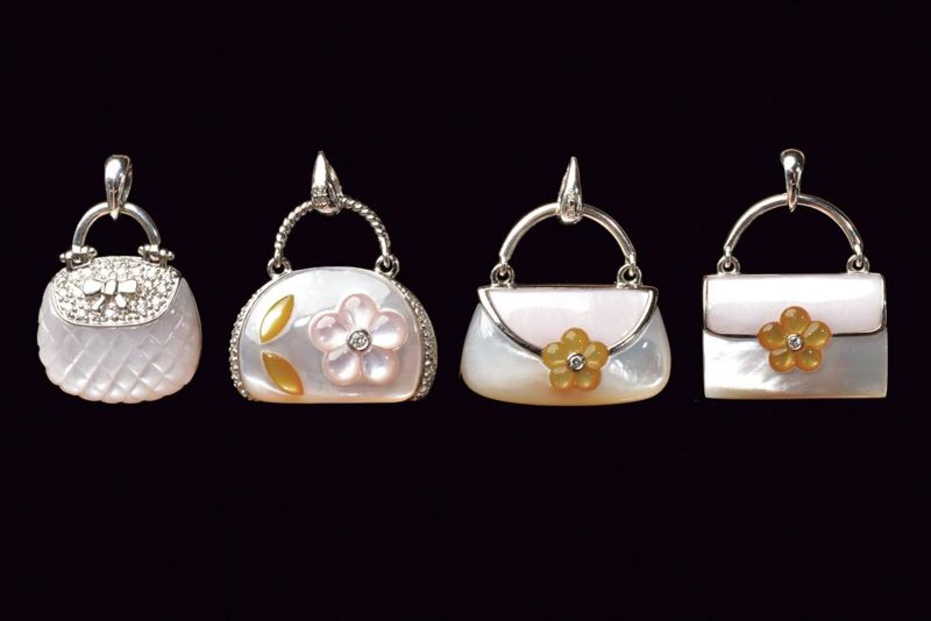 Lot of four handbag shaped gold and MOP charm pendants