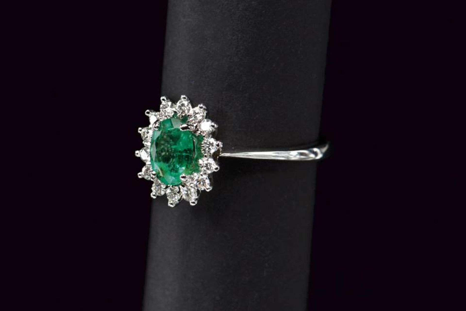 MV white gold oval emerald ring with diamond surround