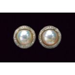 Pair of clip earrings with mab pearls and diamonds