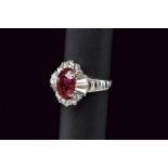 White gold oval ruby ring with diamond surround