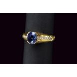 Oval sapphire and diamond yellow gold ring