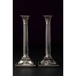 A sterling silver pair of candlesticks