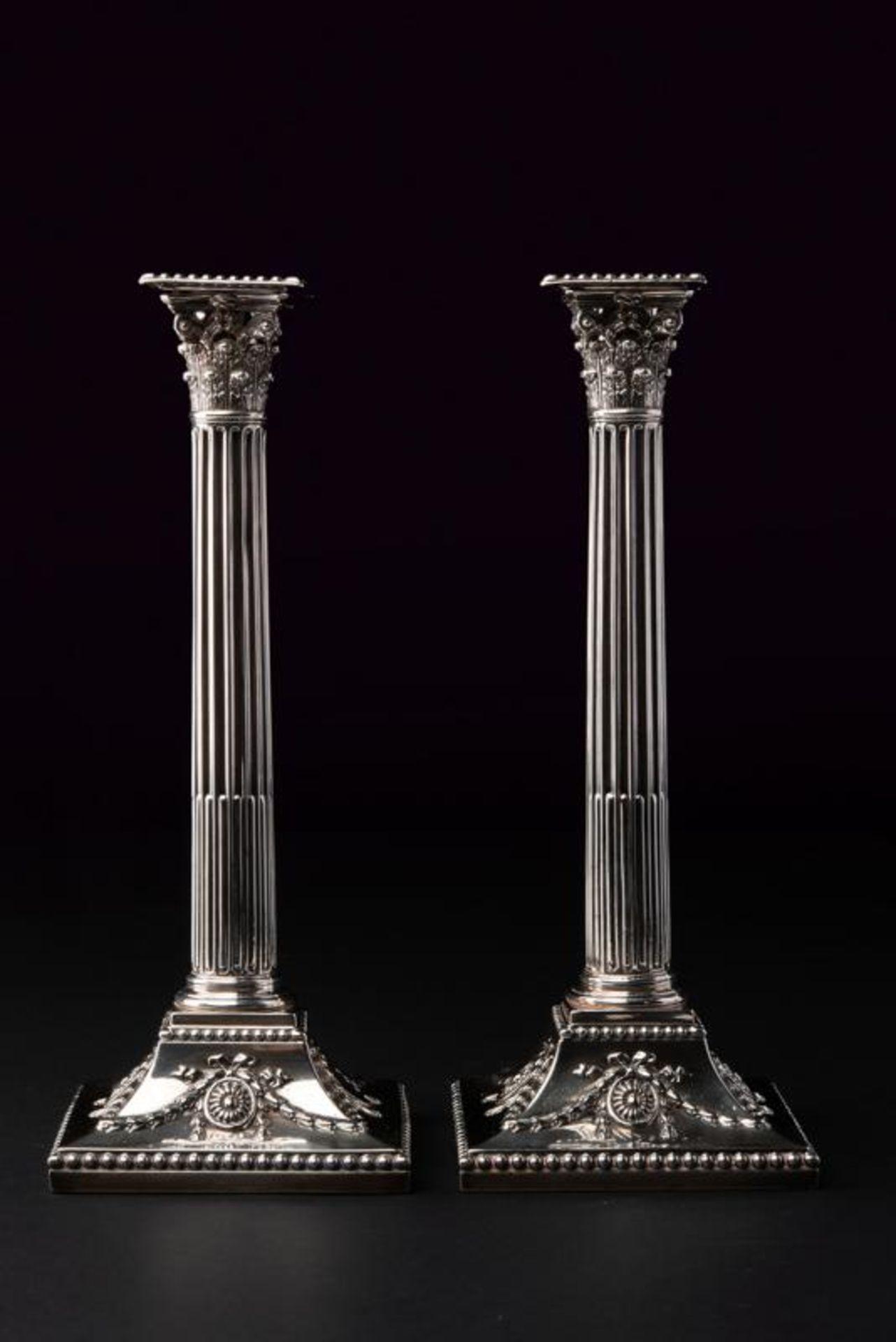 A sterling silver pair of candlesticks