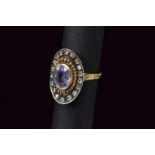 Silver topped gold ring set with blue sapphire and diamonds
