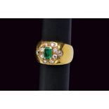 Band gold ring set with emerald and diamonds