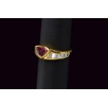 Gold ring set with triangular ruby and baguette diamonds