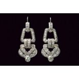 A pair of Art Déco platinum and diamond pendant earrings. c. 1920