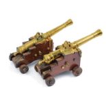 A pair of small bronze cannons on carriages
