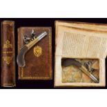 A flintlock pocket pistol hidden in a book