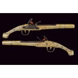 An exceptional pair of gilt-silver flintlock pistols