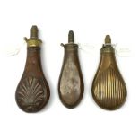 Three Victorian Sykes Patent copper and brass powder flasks, one embossed with stylised shells, one