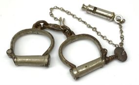 Pair of 1920's Hiatt nickel plated handcuffs marked 'Warranted Wrought' with screw-in key and a 'Met