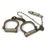 Pair of 1920's Hiatt nickel plated handcuffs marked 'Warranted Wrought' with screw-in key and a 'Met