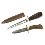 Fighting knife with 15cm steel double edged blade, one edge serrated, brass crosspiece and reeded ha