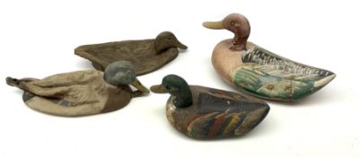 Two graduated painted wooden decoy ducks, largest L33cm; and two similar rubber decoy ducks (4)