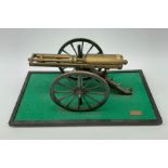 Scratch built brass model of an 1861 Gatling Gun with rotating barrels, hinged cover revealing mecha