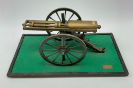 Scratch built brass model of an 1861 Gatling Gun with rotating barrels, hinged cover revealing mecha