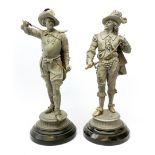 Pair of stripped 19th century spelter figures of cavaliers with brass detailing, each standing with