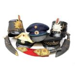 Four various 20th century German police hats; peaked cap with Metropolitan Police badge; and three k