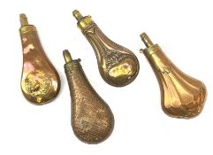 Four Victorian copper and brass powder flasks, three marked Dixon & Sons, one embossed with game bir