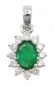 White gold oval emerald and round brilliant cut diamond cluster pendant, stamped 18K, emerald approx