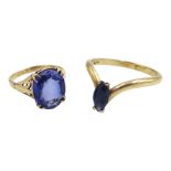 Gold marquise shaped sapphire wishbone ring and a gold synthetic oval sapphire ring, both stamped 9