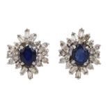 Pair of 18ct white gold oval sapphire, baguette and round brilliant cut diamond stud earrings, stamp